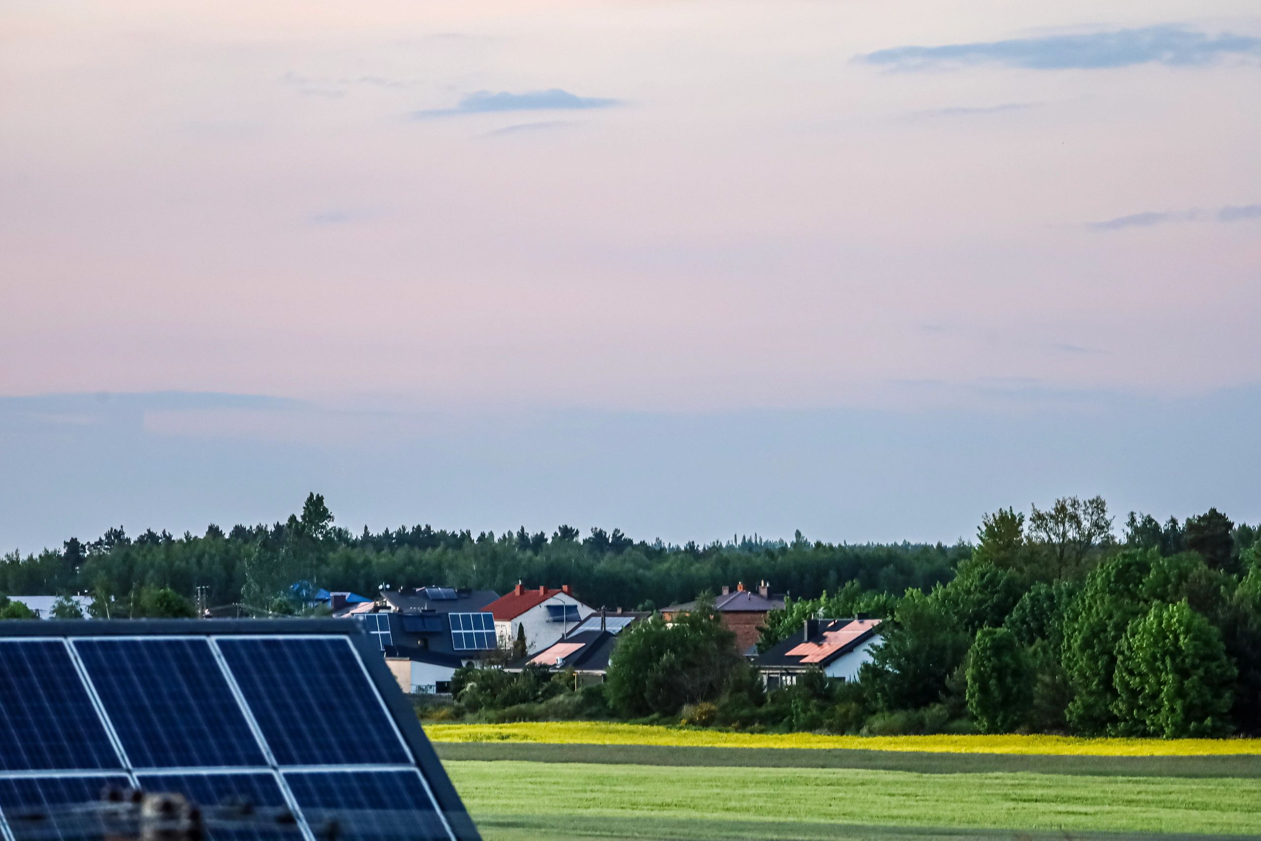 Rural home with solar panels representing off-grid support